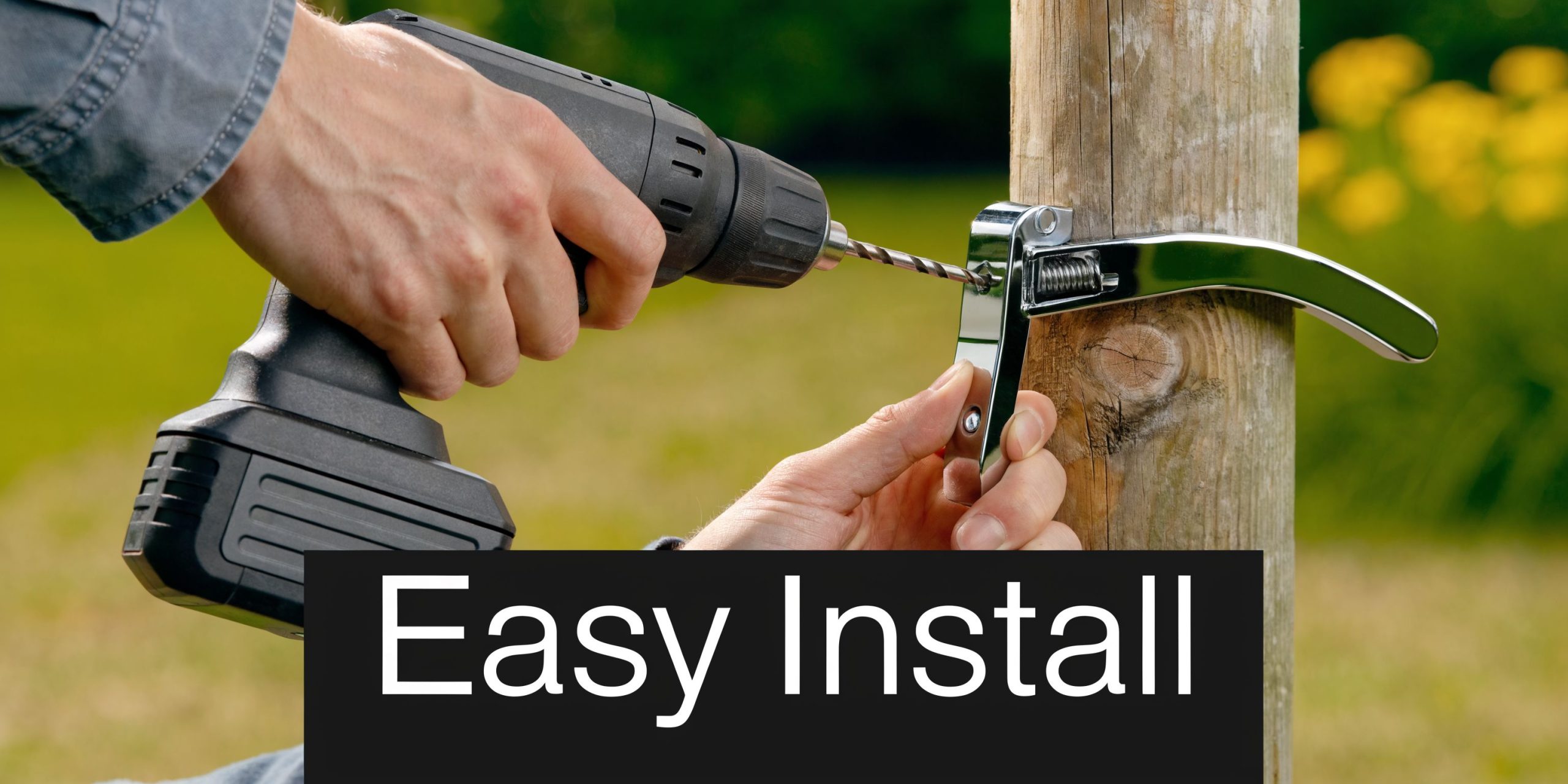 A person uses a power drill to install a shiny metal self-locking gate latch on a wooden post.