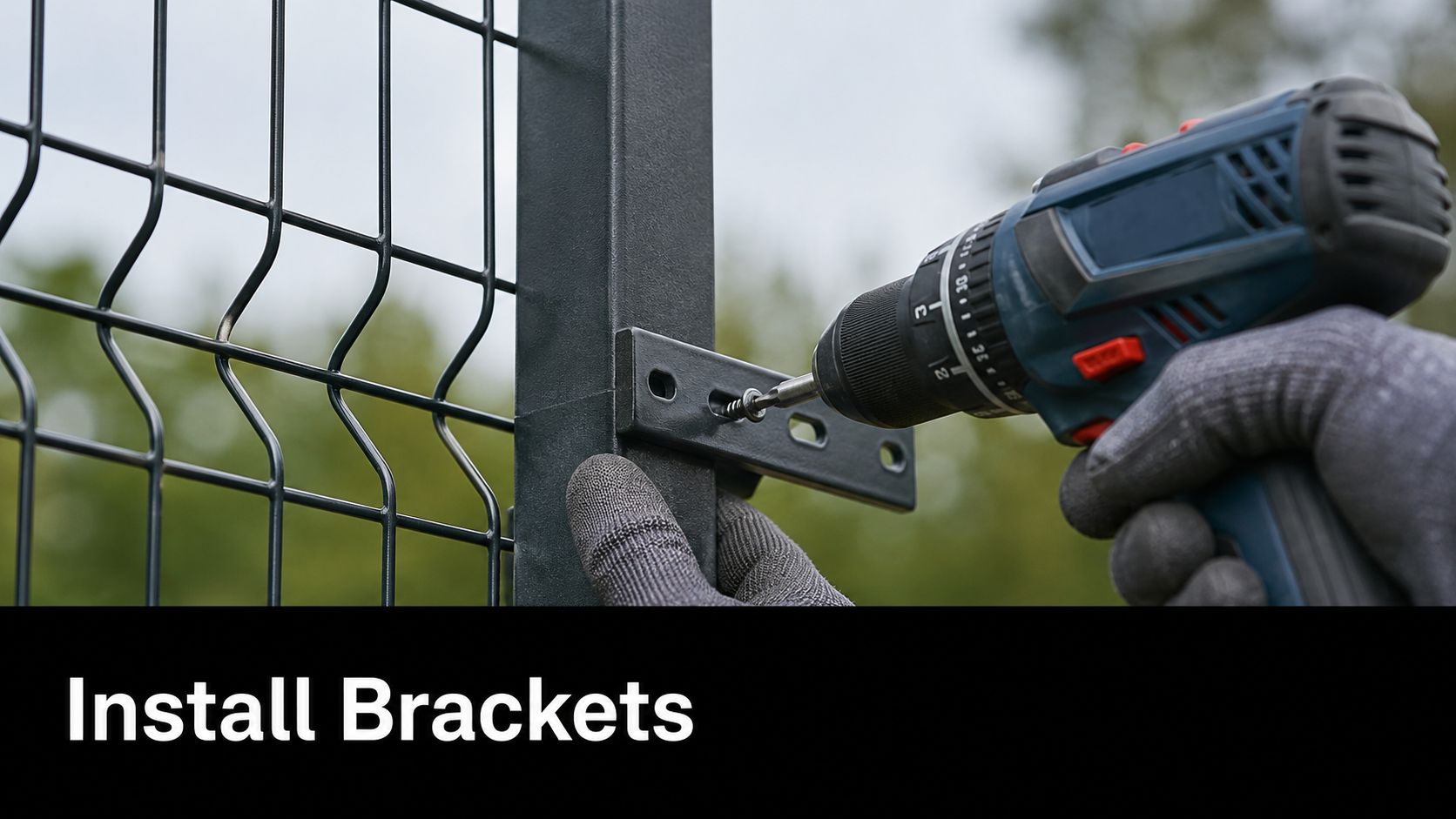 A gloved hand uses an electric drill to fasten a metal bracket onto a fence post.